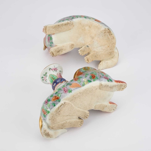 79 - A GOOD PAIR OF 19TH CENTURY CHINESE FAMILLE ROSE JOSS STICK HOLDERS as recumbent dogs, the holders f... 