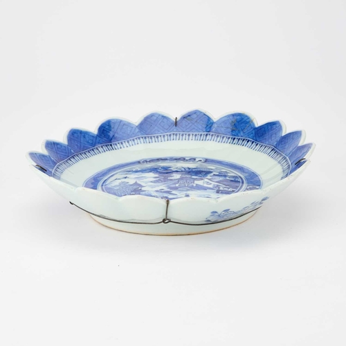 80 - A CHINESE BLUE AND WHITE DISH circular with a petal-shaped rim. 25.5cm diameter