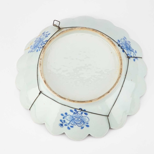 80 - A CHINESE BLUE AND WHITE DISH circular with a petal-shaped rim. 25.5cm diameter