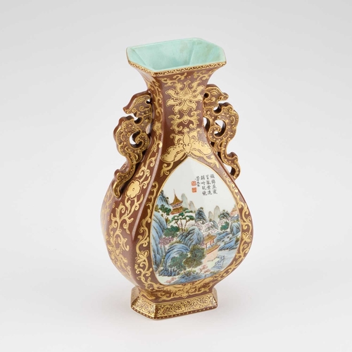 81 - A CHINESE FAUX BRONZE PORCELAIN VASE decorated with two landscape reserves, the ground richly gilded... 