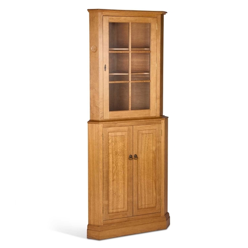 829 - ANDREW CONNING, A BUTTERFLYMAN OAK CORNER CABINET, CIRCA 1980S 
in two sections that slot together, ... 