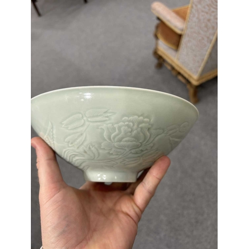 86 - A CHINESE CELADON-GROUND BOWL with incised and moulded decoration. 21cm diameterNo chips, cracks or ... 