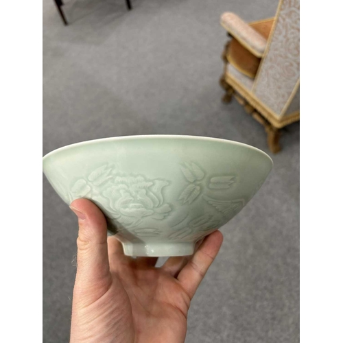 86 - A CHINESE CELADON-GROUND BOWL with incised and moulded decoration. 21cm diameterNo chips, cracks or ... 