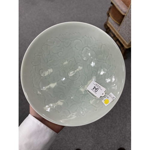 86 - A CHINESE CELADON-GROUND BOWL with incised and moulded decoration. 21cm diameterNo chips, cracks or ... 