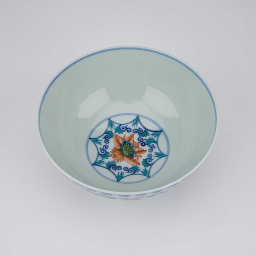 94 - A CHINESE DOUCAI 'LOTUS' BOWL enamelled around the exterior with six large lotus heads borne on leaf... 