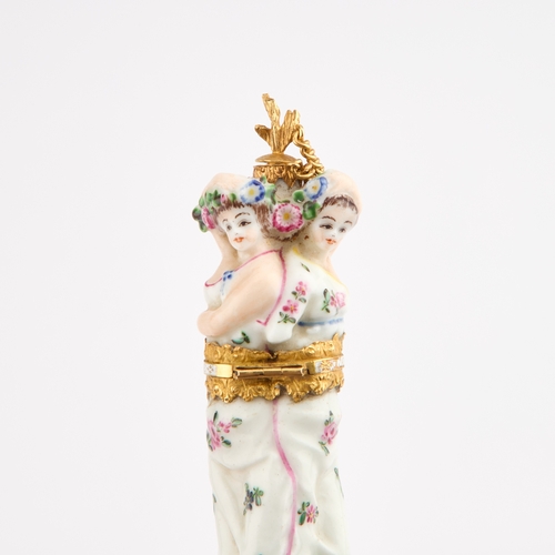 27 - A RARE CHELSEA PORCELAIN FIGURAL SCENT BOTTLE AND BODKIN CASE, CIRCA 1760 modelled as the three grac... 