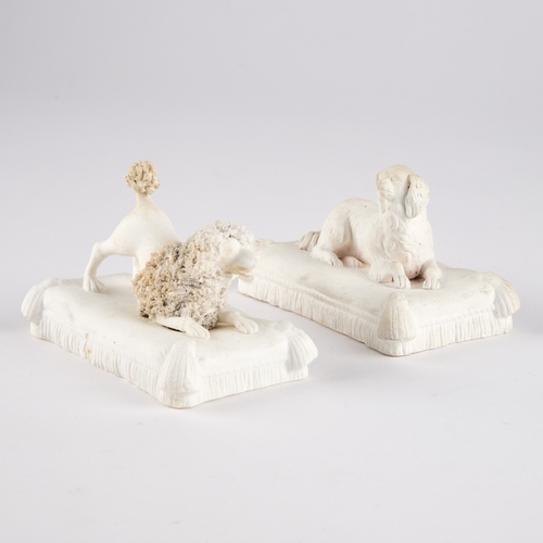 28 - A PAIR OF MINTON BISCUIT DOG MODELS, CIRCA 1830-40 modelled as a King Charles Spaniel and a Poodle, ... 