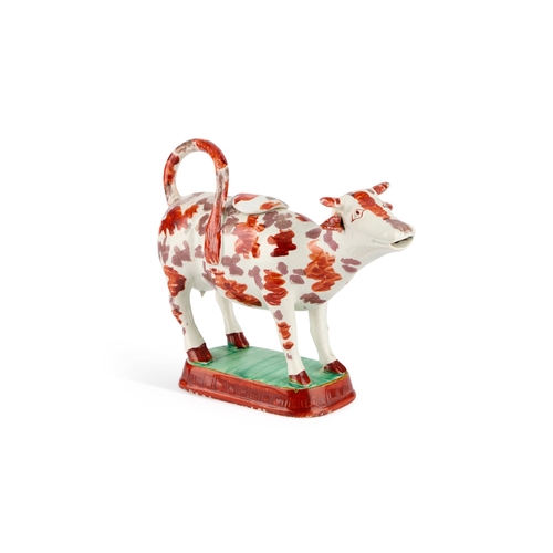 31 - A STAFFORDSHIRE POTTERY COW CREAMER, CIRCA 1830-40 of typical form, decorated with pink lustre and i... 