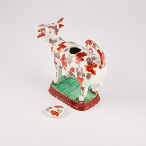 31 - A STAFFORDSHIRE POTTERY COW CREAMER, CIRCA 1830-40 of typical form, decorated with pink lustre and i... 