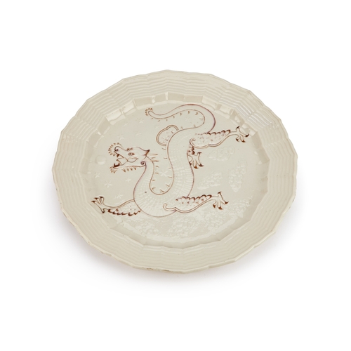 37 - A RARE BELLEEK 'DRAGON' PLATE, 19TH CENTURY ivory glazed with a barbed rim, the centre incised with ... 