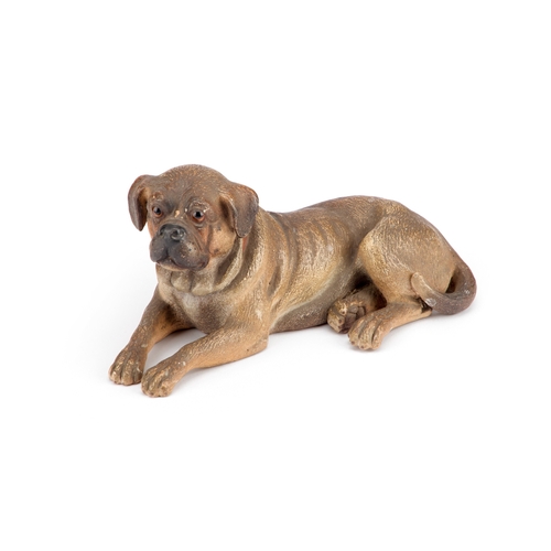 38 - AN AUSTRIAN PAINTED TERRACOTTA MODEL OF A RECUMBENT DOG late 19th Century. 19.5cm long