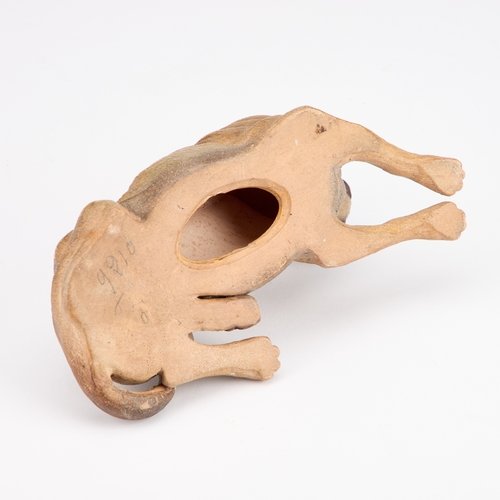 38 - AN AUSTRIAN PAINTED TERRACOTTA MODEL OF A RECUMBENT DOG late 19th Century. 19.5cm long