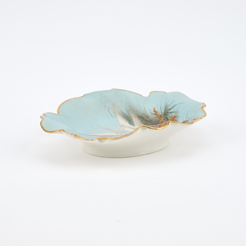 54 - A ROYAL WORCESTER PIN TRAY BY CHARLES BALDWYN painted with swans on a pale blue matte ground with gi... 