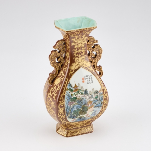 57 - A CHINESE FAUX BRONZE PORCELAIN VASE decorated with two landscape reserves, the ground richly gilded... 