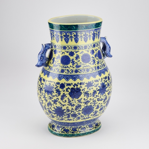 60 - A LARGE MING STYLE VASE, HU decorated in underglaze blue and yellow with scrolling foliage, bears un... 