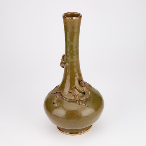 68 - A CHINESE TEA-DUST GLAZED BOTTLE-SHAPED VASE worked with a chi-dragon in high relief. 32cm high... 