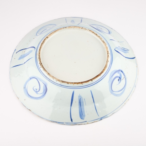 73 - A BLUE AND WHITE KRAAK PORCELAIN DISH, WANI PERIOD typically decorated below the foliate rim with la... 