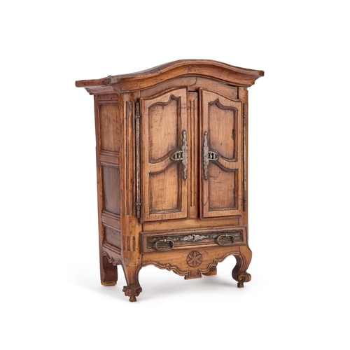 829 - AN ANTIQUE CARVED MINIATURE ARMOIRE with carved initials on the top, fitted with a pair of doors and... 