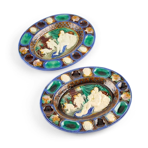 105 - A PAIR OF CONTINENTAL MAJOLICA OVAL DISHES each moulded with Classical figures. (2) 25.5cm long... 