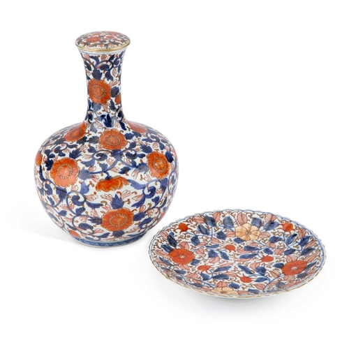 131 - A JAPANESE IMARI BOTTLE VASE AND STOPPER, 19TH CENTURY together with an Imari fluted plate. (3) Vase... 