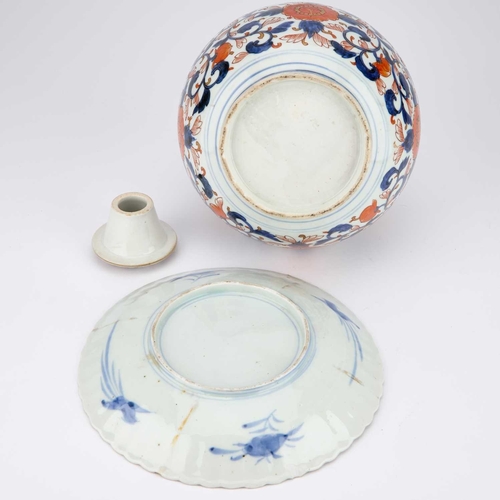 131 - A JAPANESE IMARI BOTTLE VASE AND STOPPER, 19TH CENTURY together with an Imari fluted plate. (3) Vase... 