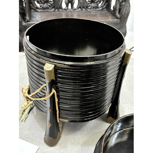 197 - A JAPANESE LACQUER STORAGE BOX (KARABITSU) of ribbed cylindrical form raised on four splayed support... 