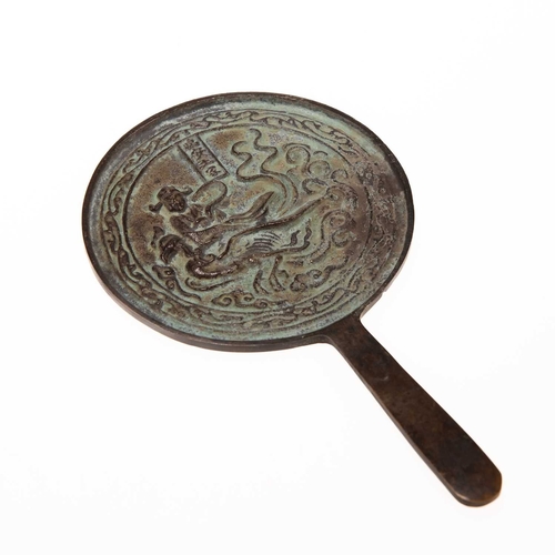 204 - A CHINESE BRONZE MIRROR, POSSIBLY LIAO DYNASTY the circular mirror with a tapering handle, decorated... 