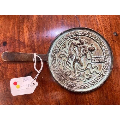 204 - A CHINESE BRONZE MIRROR, POSSIBLY LIAO DYNASTY the circular mirror with a tapering handle, decorated... 