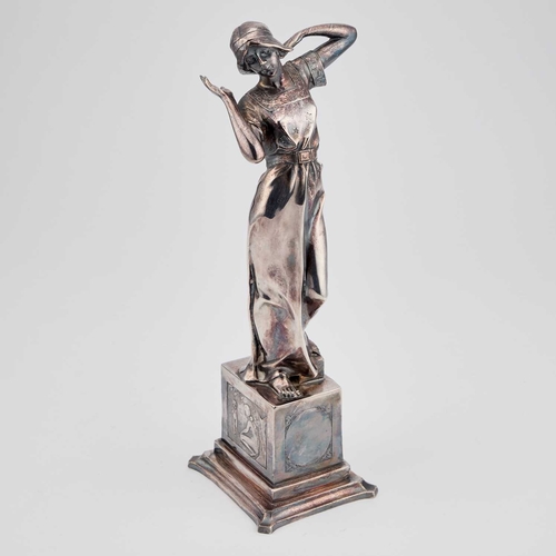 218 - A SECESSIONIST SILVERED METAL FIGURE, CIRCA 1900 cast as a girl standing on a rectangular plinth, in... 