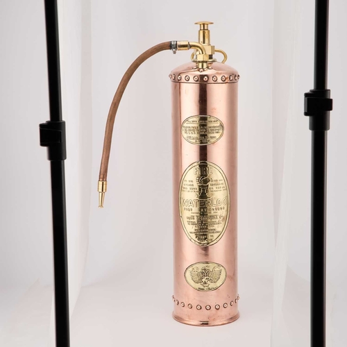 228 - A 'WATERLOO' COPPER AND BRASS FIRE EXTINGUISHER 72cm high