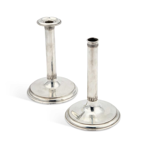 236 - A PAIR OF LIBERTY & CO TUDRIC PEWTER CANDLESTICKS each with plain semi-faceted columns on broad circ... 