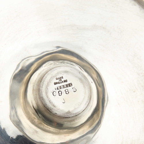 236 - A PAIR OF LIBERTY & CO TUDRIC PEWTER CANDLESTICKS each with plain semi-faceted columns on broad circ... 