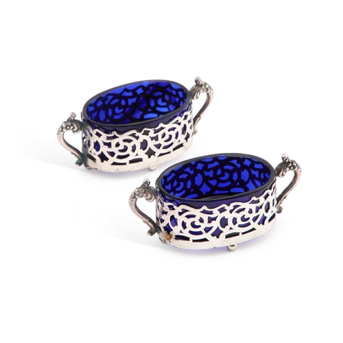 242 - A PAIR OF LATE VICTORIAN SILVER SALTS by William Devenport, Birmingham 1899, oval, with blue-glass l... 
