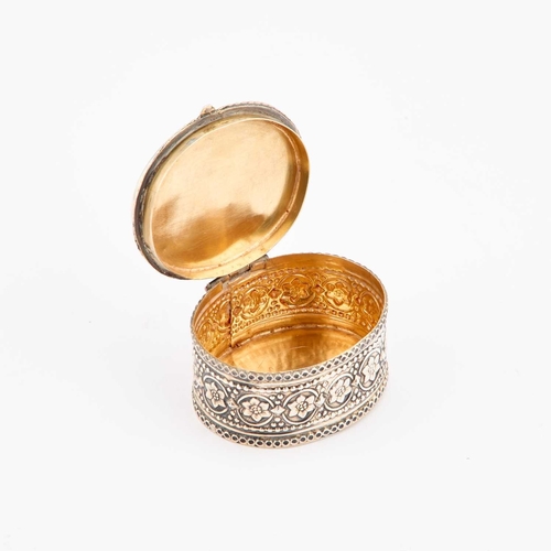 326 - AN INDIAN SILVER-GILT AND ENAMEL THEWA BOX Rajasthan, oval, decorated with figures. 5cm long, 29.5 g... 