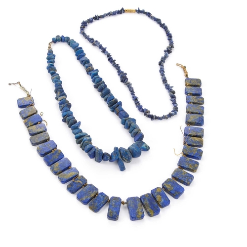337 - THREE STRANDS OF LAPIZ LASULI BEADS strung in to three necklaces of graduating rough cut lapis and o... 