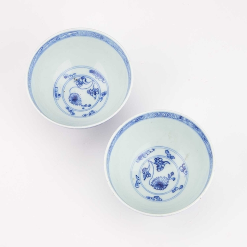 101 - A PAIR OF CHINESE BLUE AND WHITE PORCELAIN TEA BOWLS decorated with floral sprays within a band of c... 