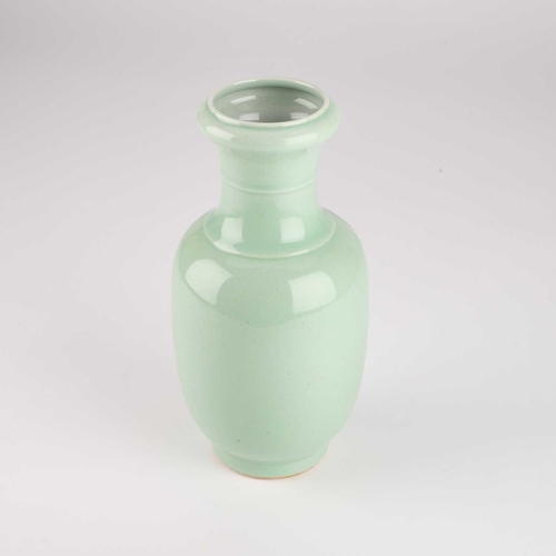 105 - A CHINESE SLIP-DECORATED CELADON VASE the ovoid body and waisted neck decorated with bats and peache... 