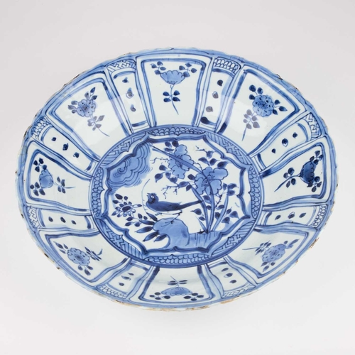 106 - A BLUE AND WHITE KRAAK PORCELAIN DISH typically decorated below the foliate rim with lappet-shaped p... 