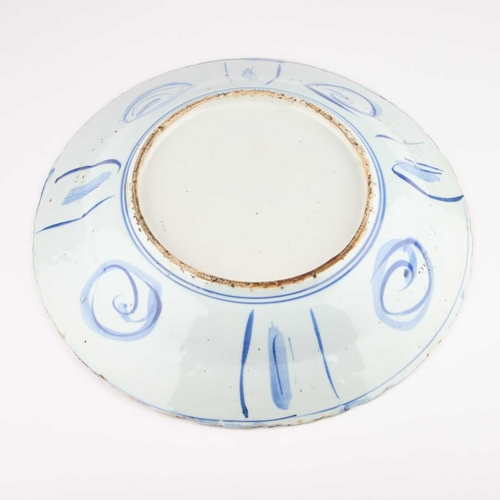 106 - A BLUE AND WHITE KRAAK PORCELAIN DISH typically decorated below the foliate rim with lappet-shaped p... 