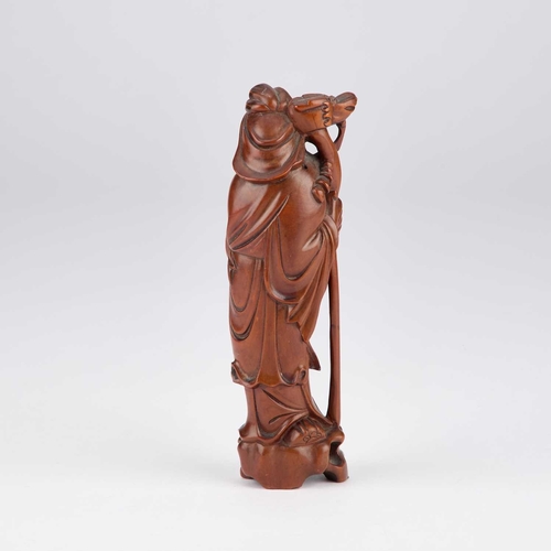 132 - A 19TH CENTURY CARVED BOXWOOD FIGURE OF A SAGE the bearded standing figure smirking beneath the slee... 