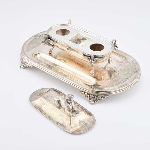 191 - A 19TH CENTURY EGYPTIAN REVIVAL SILVER-PLATED INKSTAND surmounted by a Roman bath with a sphinx cove... 