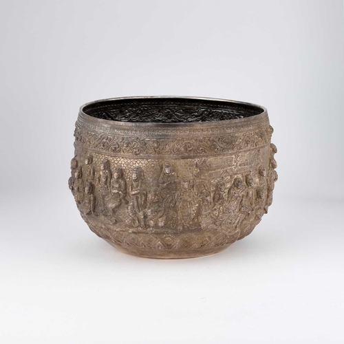 201 - A LARGE BURMESE SILVER BOWL the deep rounded sides embossed in high relief with figures. 17.5cm high... 