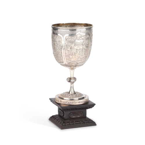 215 - A CHINESE SILVER TROPHY CUP mark of Wang Hing & Co, the goblet with chased panels of figure scen... 