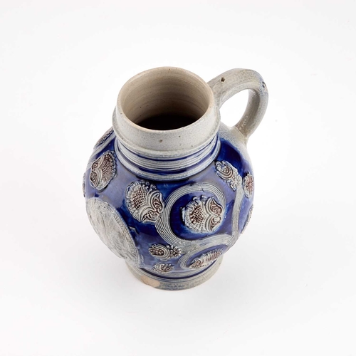 22 - A WESTERWALD STONEWARE JUG circa 1700, of almost globular form, applied with an oval titled equestri... 