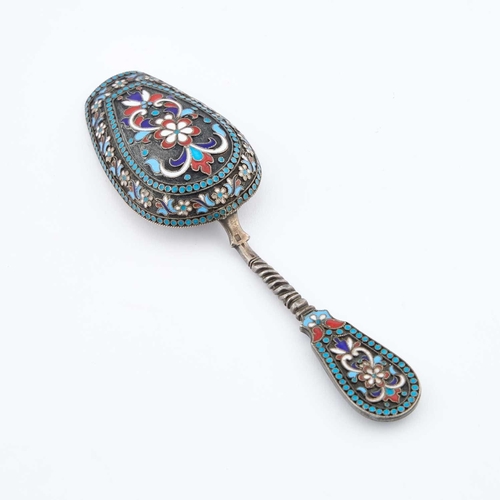 227 - A LATE 19TH CENTURY SILVER AND ENAMEL SUGAR SPOON indistinctly signed, decorated in red, white, blue... 