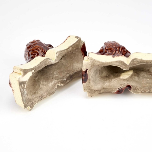 24 - A PAIR OF VICTORIAN TREACLE-GLAZED POTTERY MODELS OF RECUMBENT LIONS (2) 14.5cm long