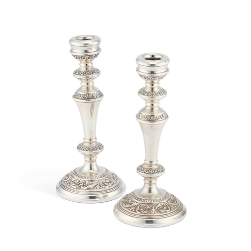 298 - A PAIR OF ELIZABETH II SILVER CANDLESTICKS by W I Broadway & Co, Birmingham 1973, chased with sc... 