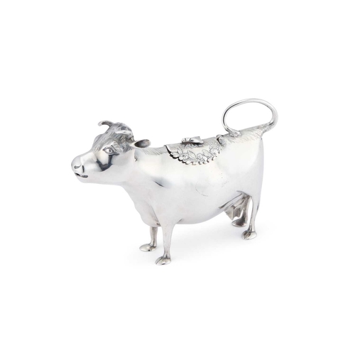 423 - AN EARLY GEORGE III SILVER COW CREAMER by John Schuppe, London 1760, modelled as a cow, standing on ... 