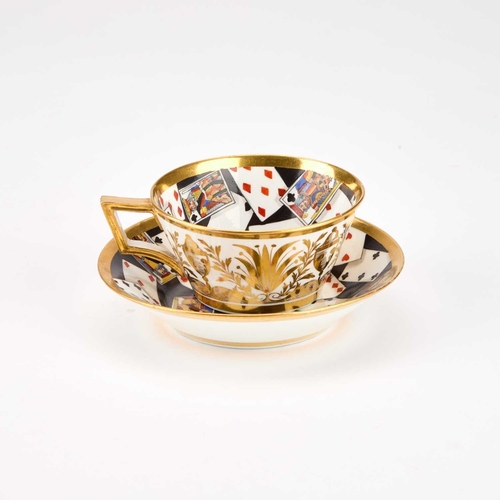 51 - A RARE DERBY TROMPE L'OEIL 'PLAYING CARDS' CUP AND SAUCER, CIRCA 1815 boldly painted with a deck of ... 