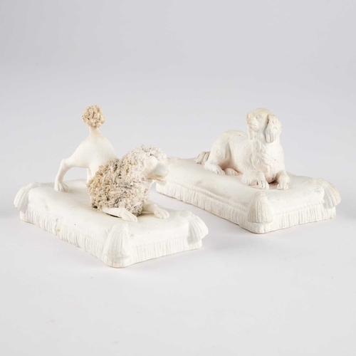 53 - A PAIR OF MINTON BISCUIT DOG MODELS, CIRCA 1830-40 modelled as a King Charles Spaniel and a Poodle, ... 